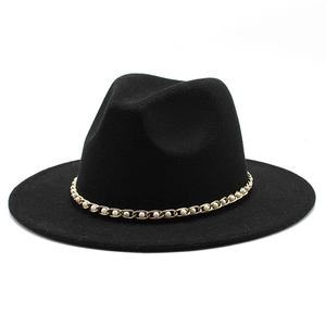 Close-up of black wool felt fedora with elegant gold chain and pearl decorative band