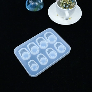 Macro shot of 8-cavity teardrop silicone mold for DIY resin jewelry making on black background
