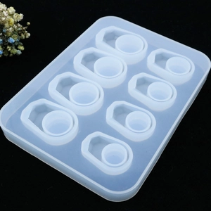 Detail of 8-hole translucent silicone mold for DIY resin rings on a black background