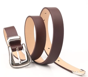 Detail of dark brown lychee texture leather belt with a vintage silver textured buckle