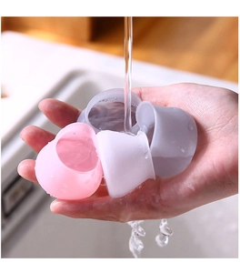 Close-up of silicone furniture leg covers being washed under running water