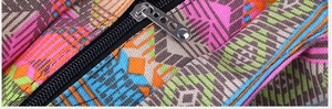 Macro detail of geometric woven canvas bag with black nylon zipper and metal puller