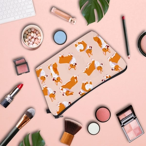 Flat lay of Corgi print waterproof makeup bag with cosmetics on pink background