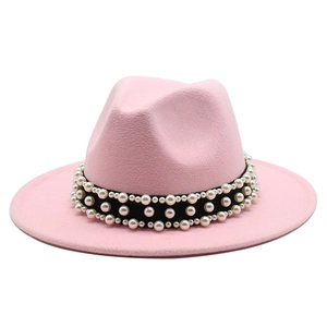 Detail of pink wool fedora hat featuring black ribbon and elegant faux pearls