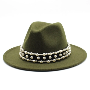 Detail of olive green wool fedora hat featuring three rows of decorative white pearls
