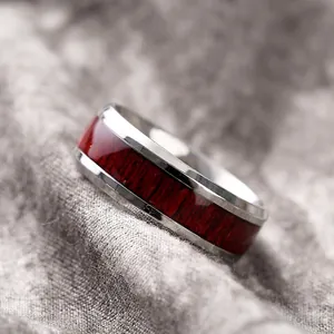 Polished titanium steel ring with inlaid dark red wood grain for men on linen background