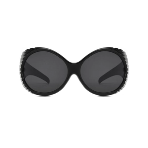 Futuristic oversized round sunglasses with thick frames and vertical striped textures