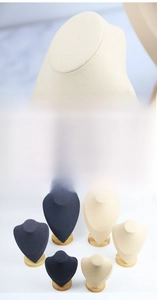 Detail of microfiber jewelry busts with natural beech wood bases for necklace display