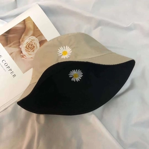Close-up of double-sided kids' bucket hat with beige fabric and daisy embroidery