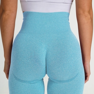Detail of high waist seamless yoga pants showing light blue knitted texture and peach lift