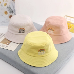 Kids rainbow embroidered cotton bucket hats in cream, pink and yellow for sun protection