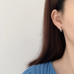 French vintage S925 sterling silver textured hoop earrings worn by a model