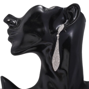 Detailed close-up of sparkling full-crystal water drop earrings on a black bust stand