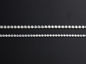 Detailed macro view of dual layered silver chains with sparkling pavé set round zircon crystals