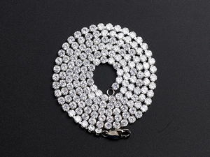 Close-up of hip-hop silver tennis necklace with sparkling cubic zirconia on black background