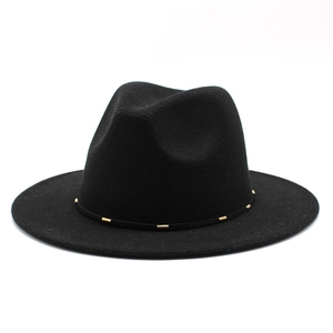 Detail of black wool fedora hat featuring a thin band with gold metal cylinder accents