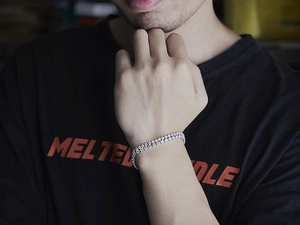 Close-up of hiphop silver bracelet with sparkling crystals on a model's wrist