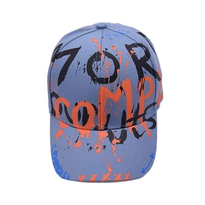 Close-up of street style graffiti baseball cap with black and orange lettering detail