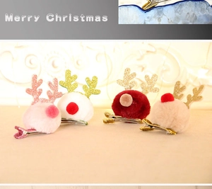 Detail view of colorful reindeer antler hair clips with plush balls for Christmas decor