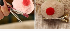 Detailed view of plush Christmas reindeer antler hair clips with glitter accents