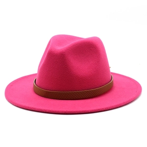 Detail of rose red wool fedora hat featuring a brown snakeskin textured leather belt band