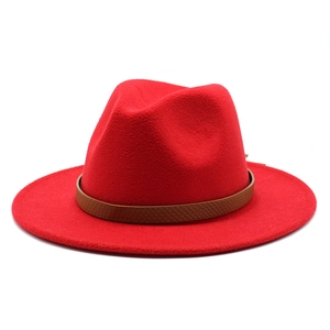 Detail of red fedora hat with wide brim featuring a brown snakeskin leather band strap