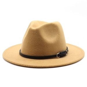 Detail of camel wool fedora hat featuring a slim black leather band and gold buckle