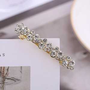 Elegant gold alloy hair clip with clustered sparkling rhinestones on a white display card