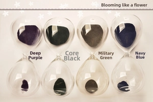 Four colorful magnetic hourglasses in purple, black, green and blue glass containers