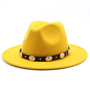 Detail of yellow wool fedora featuring a black leather belt with vintage metal studs