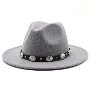 Detailed view of light gray wool felt fedora with black leather band and silver buckles