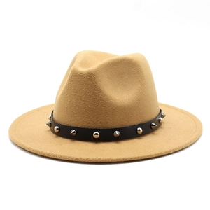 Detail of camel wool fedora hat featuring black band with silver punk rock metal studs