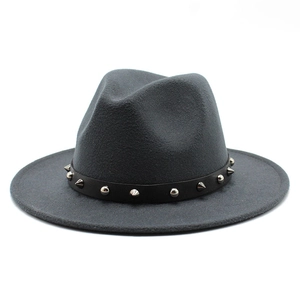 Detail of dark gray fedora hat with black leather strap featuring silver punk rivets