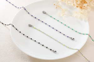 Detail of titanium steel bead necklaces with colorful resin accents and lobster clasp