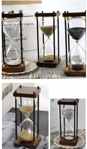Close-up of vintage wooden hourglass timer with metallic pillars and fine sand detail