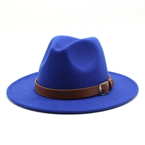 Detail of royal blue wool fedora hat featuring a brown faux leather belt and metal buckle