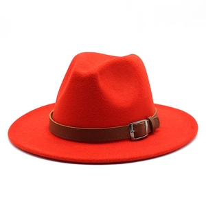 Detail of red wool fedora hat featuring wide brim and brown leather belt with metal buckle