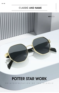 Detailed close-up of octagonal gold metal frame and black lenses on a minimal surface