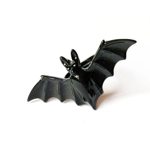 Close-up detail of gothic black bat ring with realistic wings for Halloween style