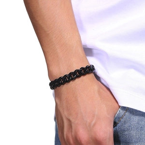 Classic men's black stainless steel Cuban link bracelet styled on a male wrist