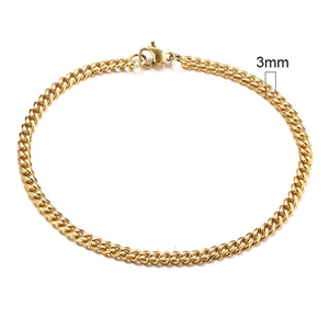 Top view of 3mm wide gold plated stainless steel Cuban link chain on white background