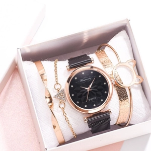 Close-up of rose gold watch and cat-ear bracelet set displayed in a white gift box
