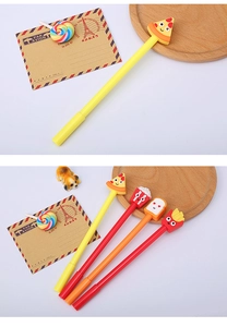 Detail of creative cartoon pens featuring pizza and fries motifs on white desk
