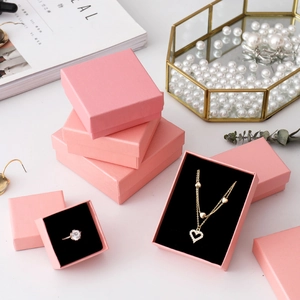 Pink jewelry gift boxes with soft black lining for rings and necklaces, macro detail view