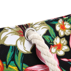Detail of floral canvas tote with silver metal eyelets and thick cotton rope handles