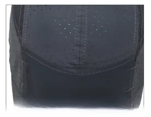 Detail of durable reinforced top stitching and laser-cut ventilation holes on grey sun hat