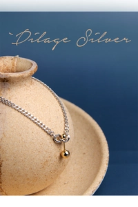 Artistic detail of S925 sterling silver chain with geometric dual gold balls pendant