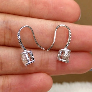 Macro view of AU750 hallmark on 18K white gold earrings with square-cut zircon stones