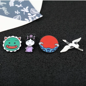 Set of four metal enamel pins featuring crane, sun wave, monster, and girl characters