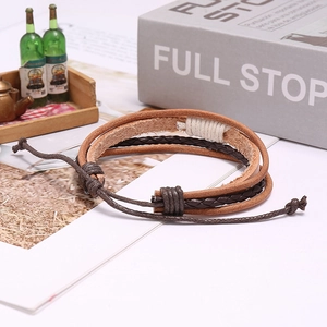 Detailed macro shot of a brown layered leather braided bracelet with adjustable cord
